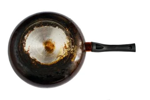 Frying pan with a dirty, greasy bottom isolated on white background. Stock Photos