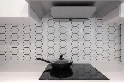 Frying pan on electric stove in the kitchen Stock Photos