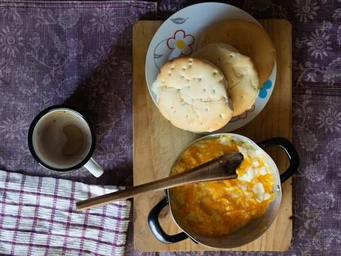 A frying pan with fried eggs, bread and a cup of coffee, a simple and real .. Stock Photos