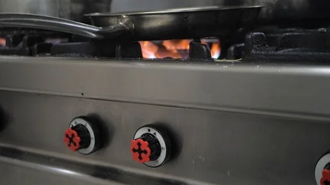 Frying pan on gas stove Stock Footage 119391329