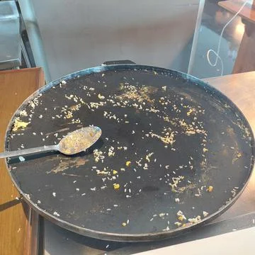 A frying pan that has been used to make fried rice Stock Photos