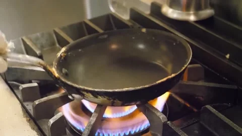 Frying Pan Heating Over Blue Flame on Commercial Gas Stove Burner Close Up Stock-Footage 347688035