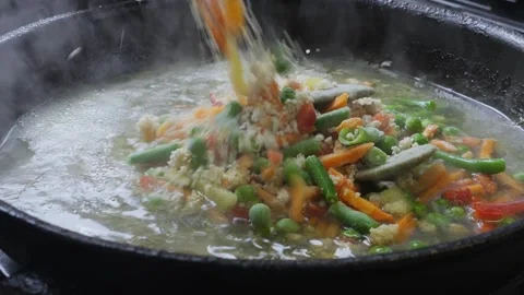 In a frying pan with minced meat and vegetables, udon noodles Stock Footage 296550352