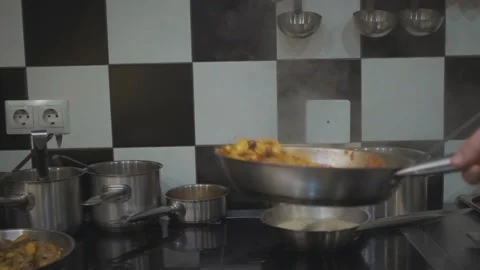 Frying pan with pasta tosses on the background of the kitchen close-up Stock Footage 141280368