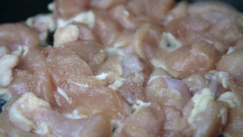 In a frying pan, pieces of chicken are turned over. Stock Footage 88159574