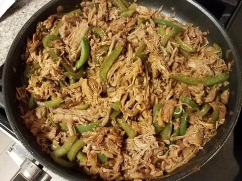 Frying pan with pulled pork and green peppers Stock Photos