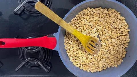 Frying pan with roasted peanuts Stock Photos