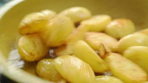 The frying pan is shaken while the potatoes are frying. Stock Footage 207023877