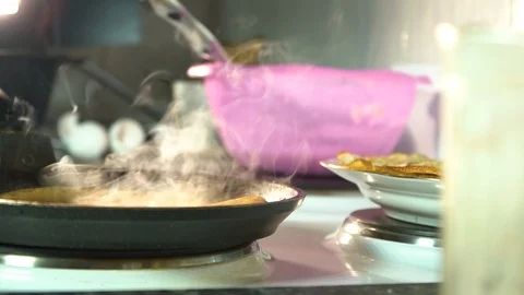 The frying pan stands on the stove. Fried pancake in a frying pan Stock-Footage 85950909