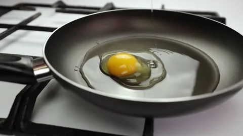 Frying pan on the stove. Cooking breakfast, homemade egg. Kitchen, egg Stock Footage 236759994