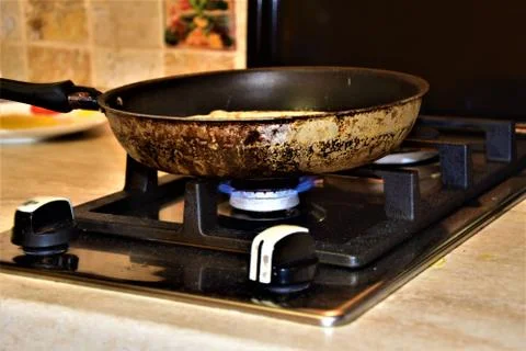 Frying pan on the stove Stock Photos