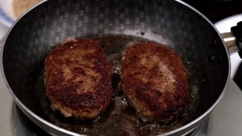 In frying pan, two cutlets are fried in breadcrumbs with crispy crust. close-up. Stock Footage 174557587