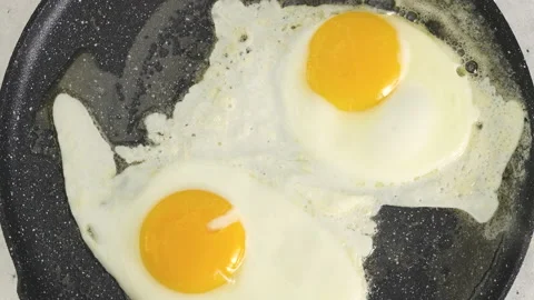 Frying pan with two eggs. English breakfast recipe Stock Footage 225926258