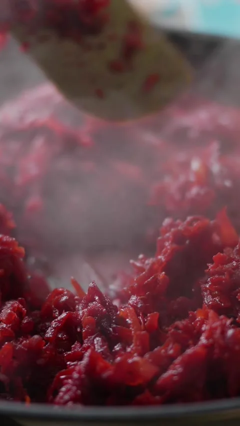 Frying pan on which shredded beetroot is stewed. Stock Footage 312315530