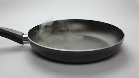 Frying pan on a white background. Close-up of black kitchen utensils Stock Footage 236720292