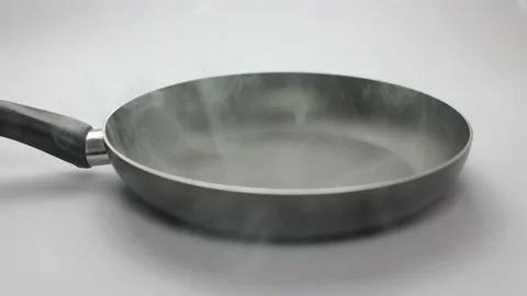 Frying pan on a white background. Close-up of black kitchen utensils Stock Footage 236720297