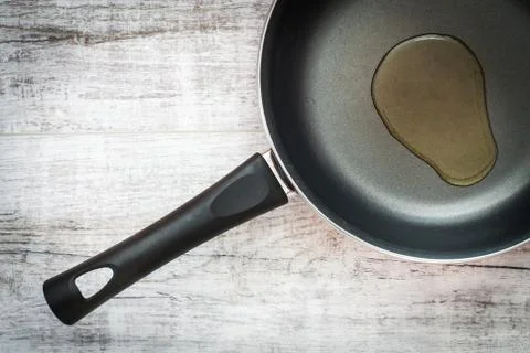 Frying pan on wooden table Stock Photos