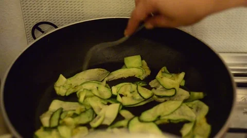 Frying pan with zucchini on the fire Stock Footage 78626919