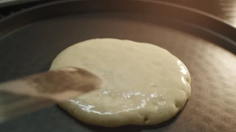 Frying pancake is flip over with a spatula on a hot frying pan in slow motion 스톡 동영상 151361543