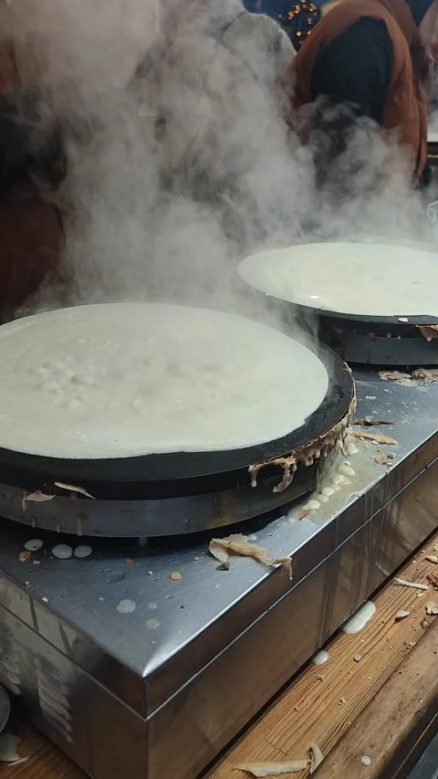 Frying pancake Making pancakes outdoors Persona preparing large round Vertical Stock Footage 304201940