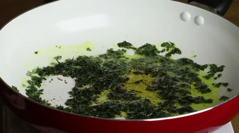 Frying parsley and garlic. Stock Footage 55710061