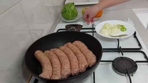 Frying Perfection: Sausages Ready for Crispy Bliss Stock-Footage 304867962