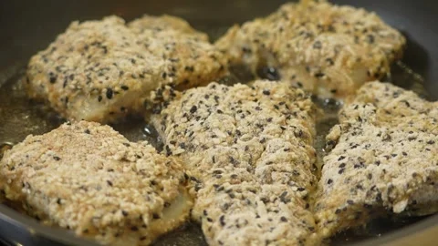 Frying pieces of battered fish on a pan Stock Footage 305907804