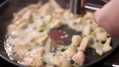 Frying pieces of chicken with garlic. Stock Footage 144024679