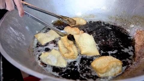 Frying pillow cake or its friend cakwe Stock Footage 268515809