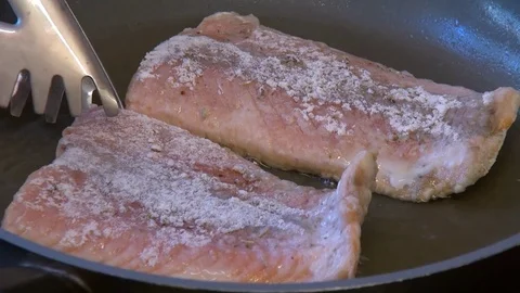 Frying pink salmon fillets in hot olive oil Stock Footage 72851045