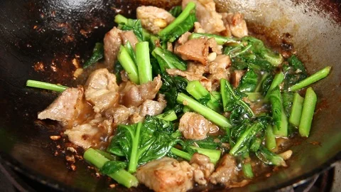 Frying pork and kale in pan, Thai food Stock Footage 94415442
