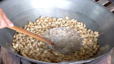 Frying pork in big wok pan with colander. Stock Footage 107669746