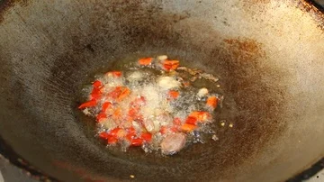 Frying pork with chili  in pan  Stock Footage 86066586