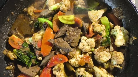 Frying pork livers with vegetables in pan, in door  Chiangmai  Thailand. Stock Footage 298219152