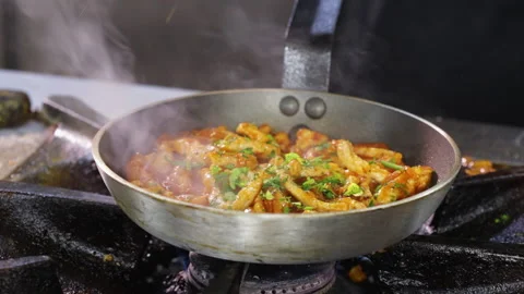 Frying pork meat strips in a pan, adding herbs - close up Stock Footage 164311739
