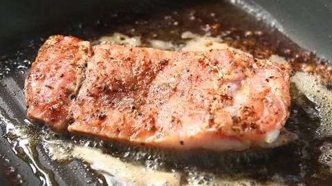 Frying pork steak in pan , in door  Chiangmai  Thailand Stock Footage 133314042