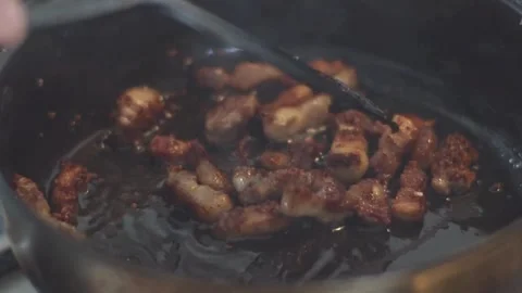 Frying pork tiny bacon dices, closeup. Classic, smoky and crispy bacon. 스톡 동영상 334643516