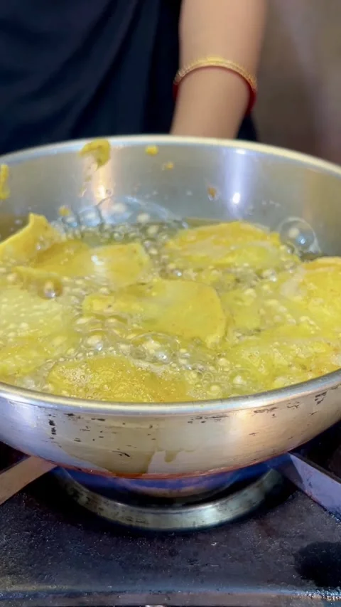 Frying potato pakora made with gram flour or besan in a frying pan. Stock Footage 287306754