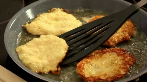Frying potato pancakes in a hot pan Stock Footage 333839077