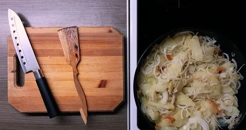 Frying potatoes and onions in a deep pan, top view. Stock Footage 128257773