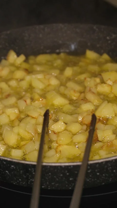 Frying potatoes in a pan with olive oil Stock Footage 297213535