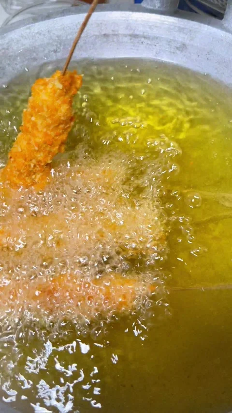 Frying Process Using Golden Breadcrumb Coated Food in Hot Oil Setting Stock Footage 333305834