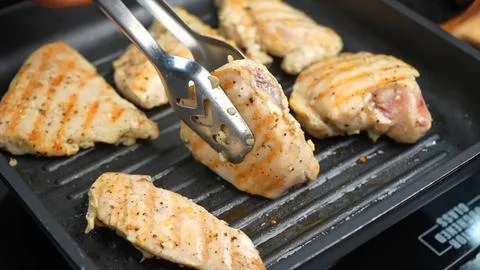 Frying Raw Chicken on grill pan Stock Photos