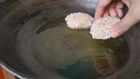 Frying Raw Chicken Nuggets on a Frying Pan Stock Footage 231360813