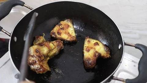 Frying of raw fish on a non stick frying pan in kitchen Stock Footage 127558323