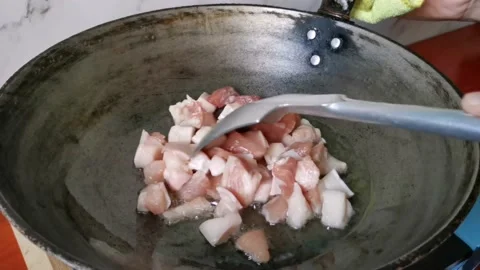 Frying Raw Pork Cubes in a Frying Pan Stock Footage 231119001