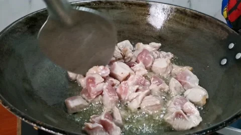 Frying Raw Pork Cubes in a Frying Pan Stock Footage 235498973