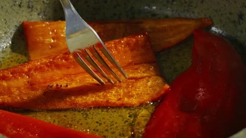 Frying red bell peppers in a pan with oil Stock Footage 138127421
