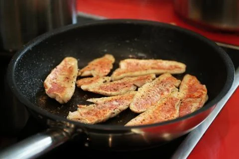 Frying red mullet fish fillets Stock Photos