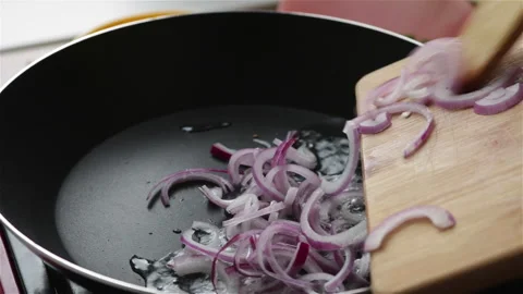 Frying red onion in pan close up Stock Footage 249917198